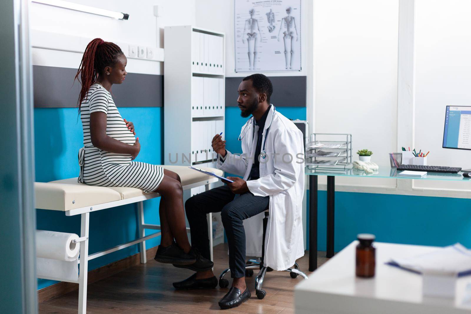 Patient expecting child and discussing with medic in cabinet about treatment and healthcare. Woman with pregnancy receiving consultation from medical specialist, preparing to give birth