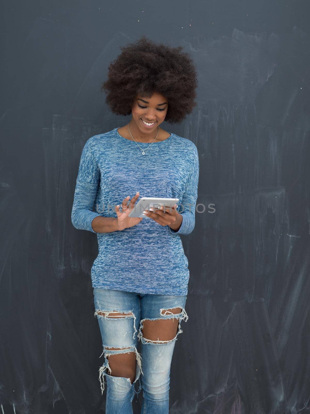 Young Happy African American Woman Using Digital Tablet  Isolated on a gray background