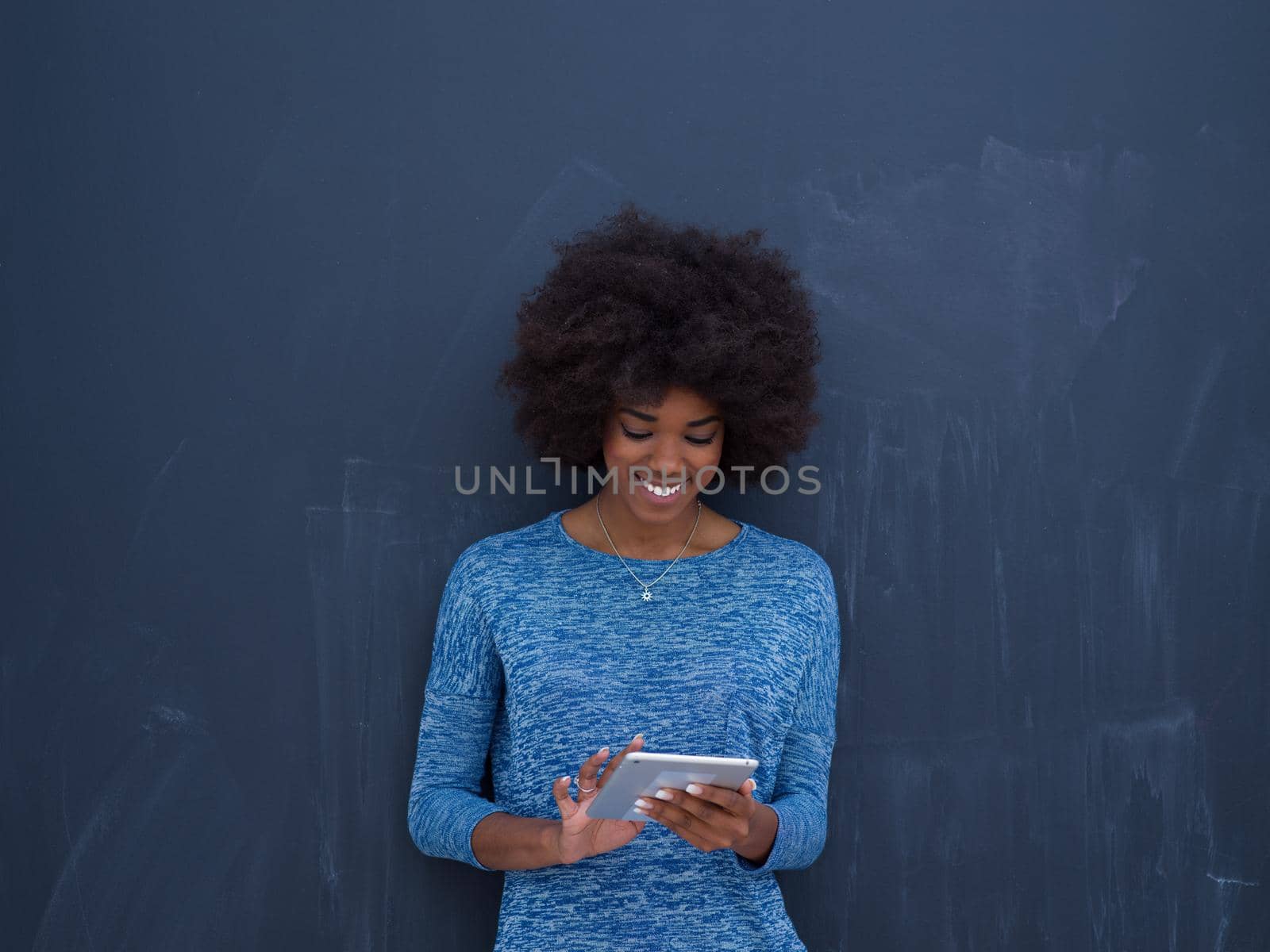 Young Happy African American Woman Using Digital Tablet  Isolated on a gray background