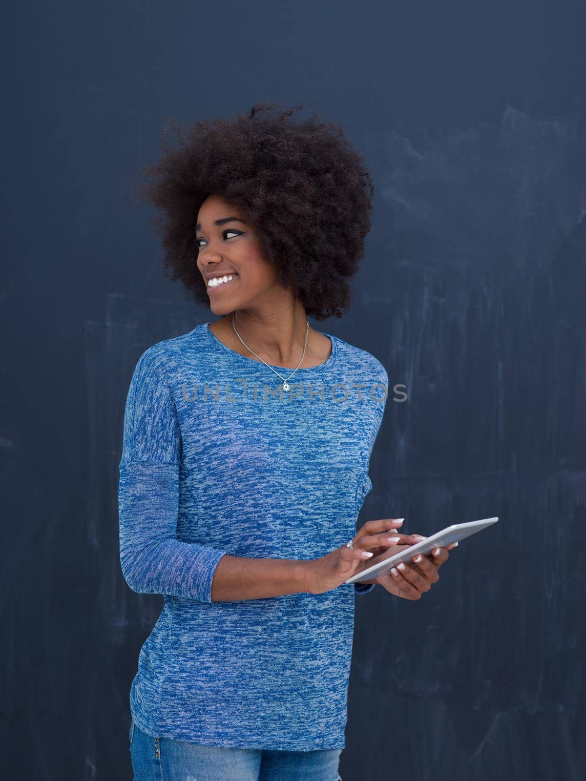 Young Happy African American Woman Using Digital Tablet  Isolated on a gray background