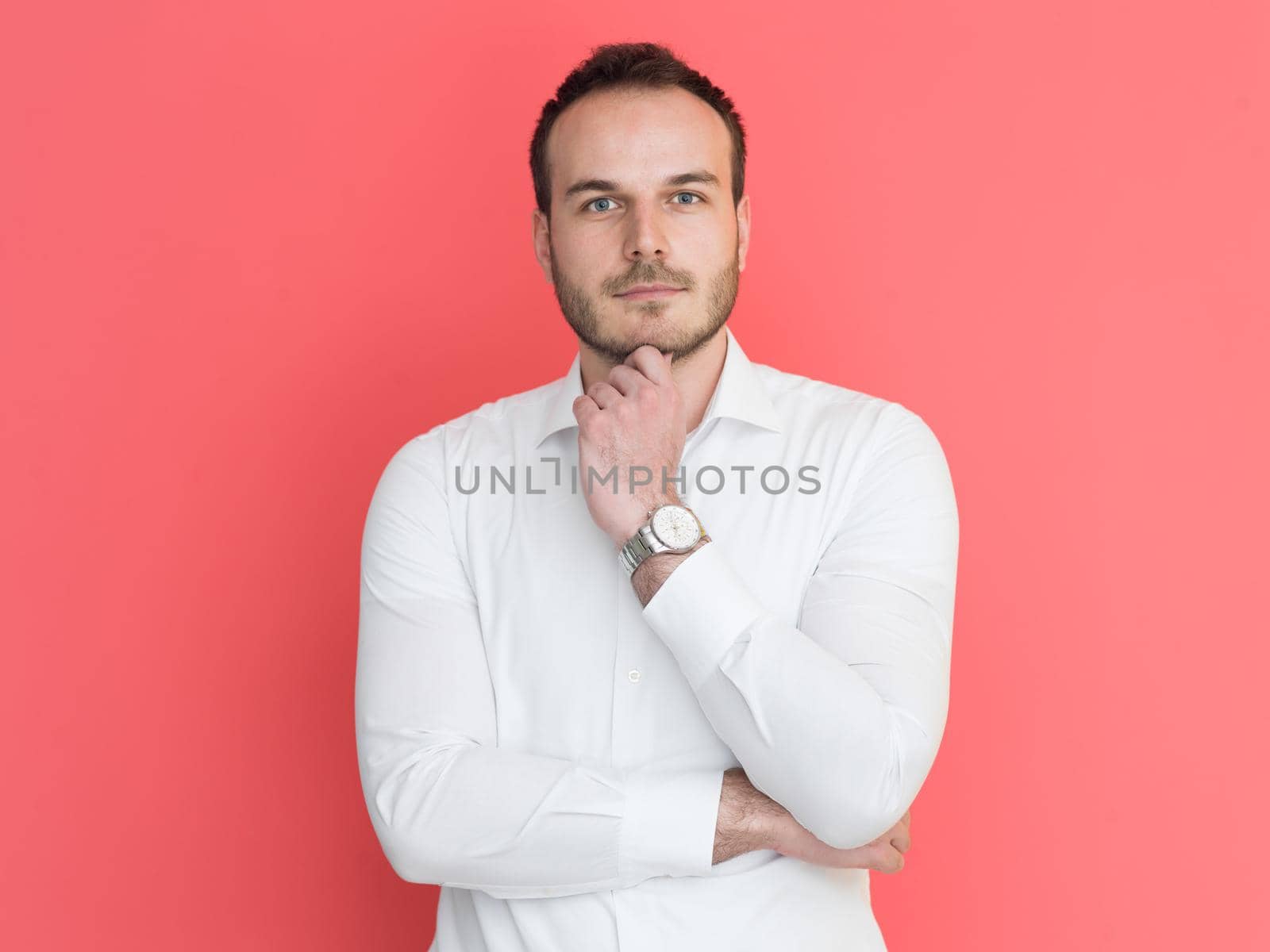 portrait of a handsome young man isolated over a red background