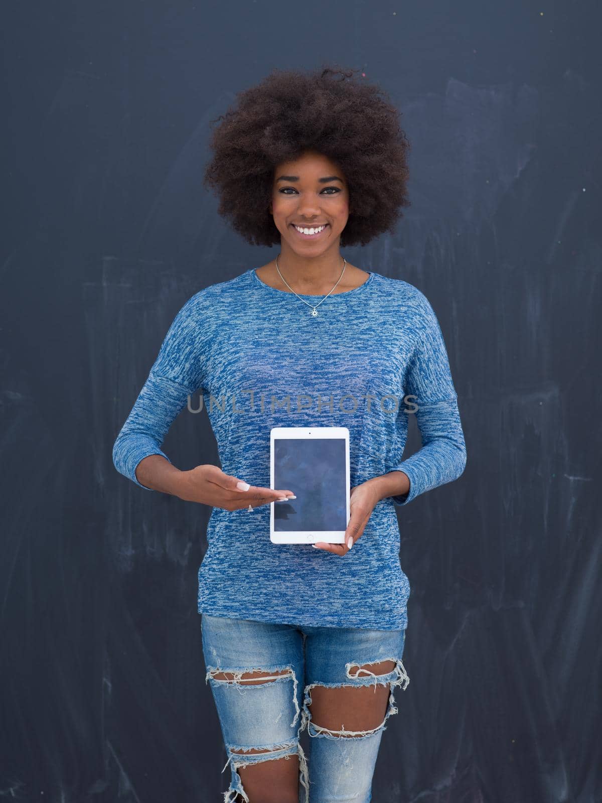 Young Happy African American Woman Using Digital Tablet  Isolated on a gray background