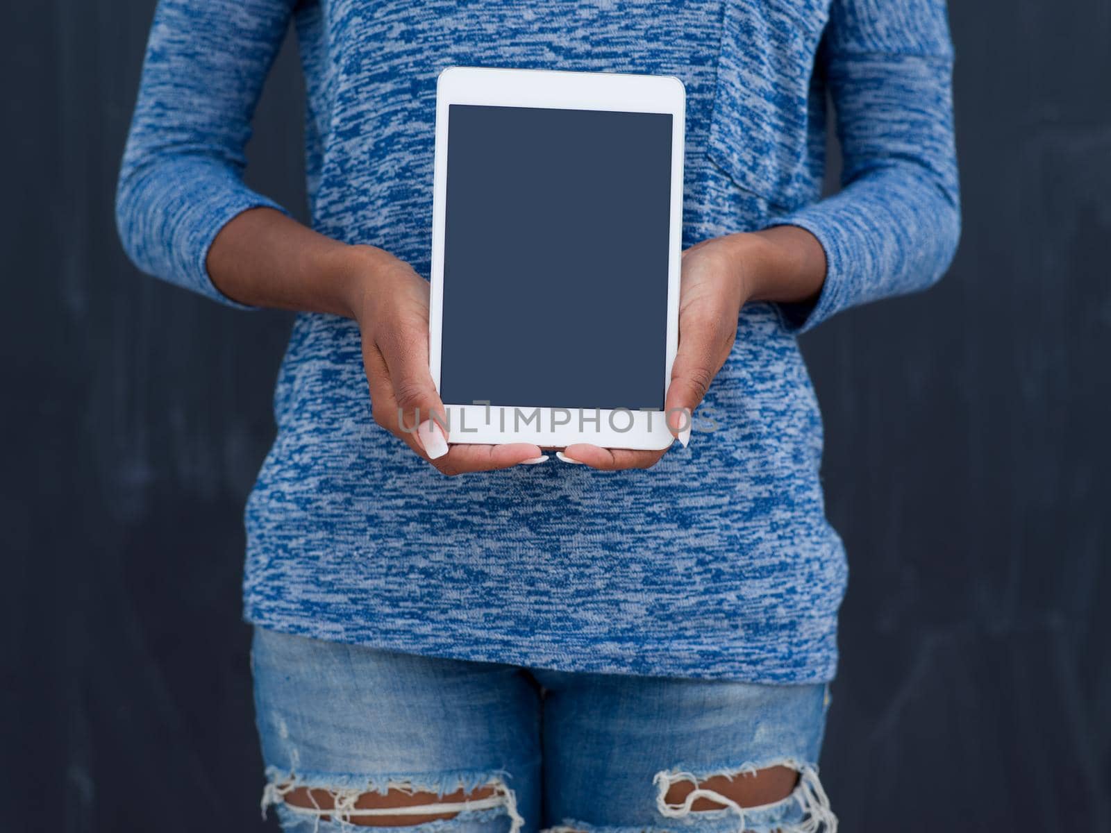 Young Happy African American Woman Using Digital Tablet  Isolated on a gray background