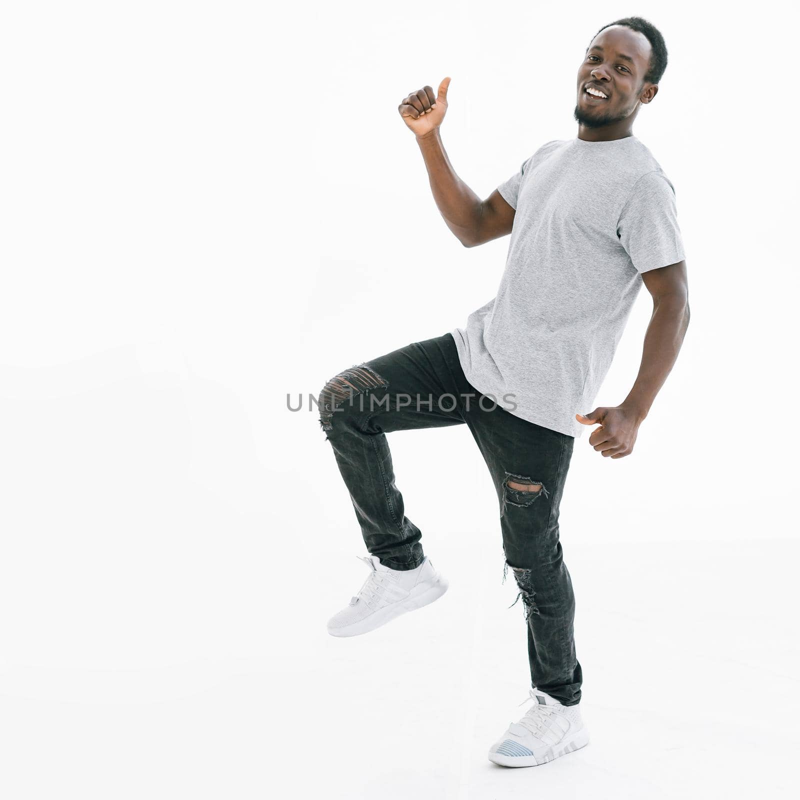side view. happy guy showing thumbs up. isolated on white background