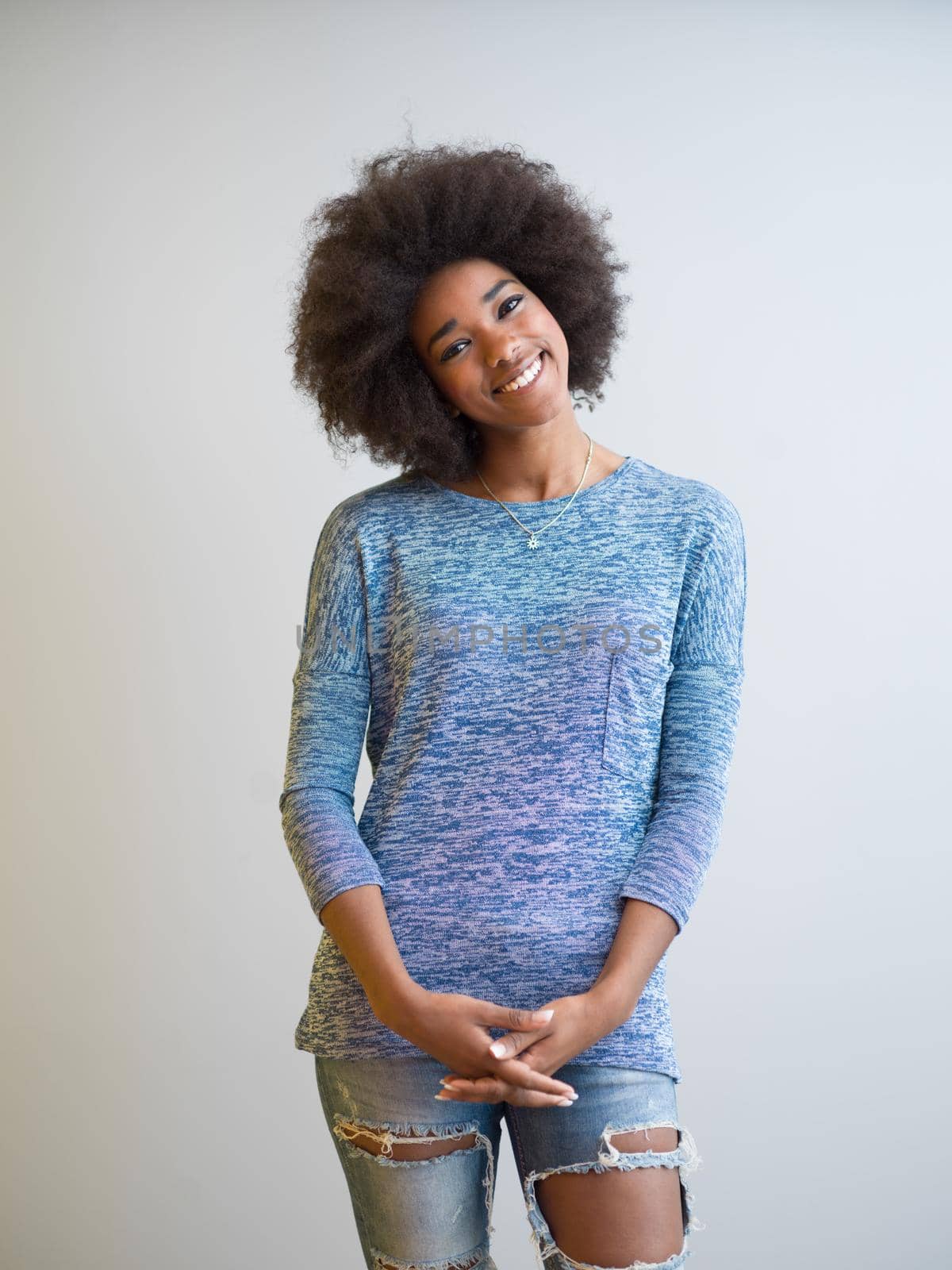 portrait of a beautiful friendly African American woman with a curly afro hairstyle and lovely smile isolated on a white background