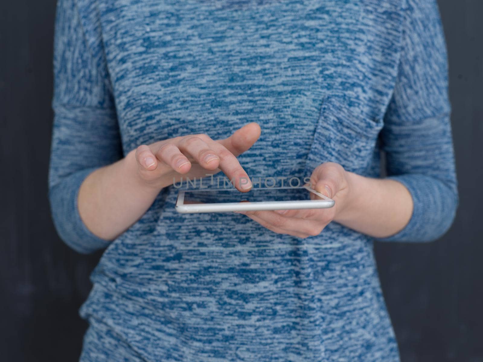 Happy young woman using tablet computer isolated over gray background
