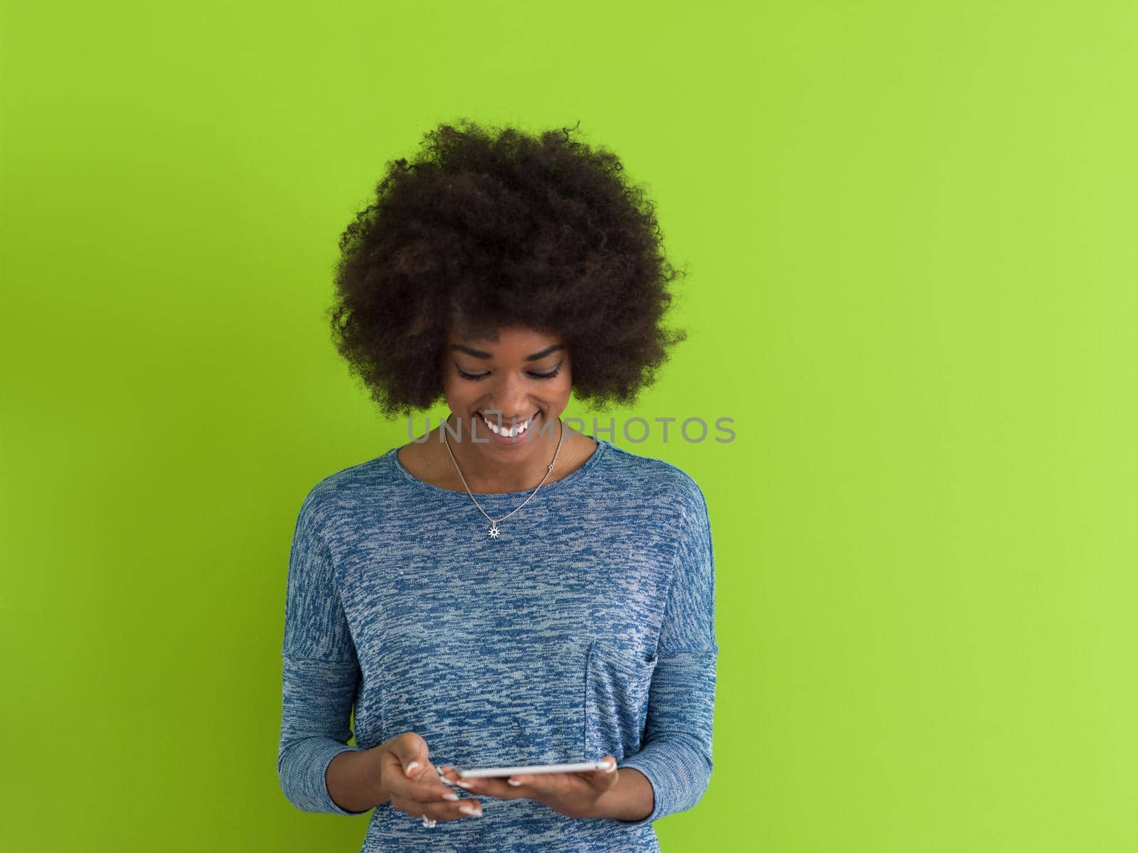 Young Happy African American Woman Using Digital Tablet  Isolated on a green background