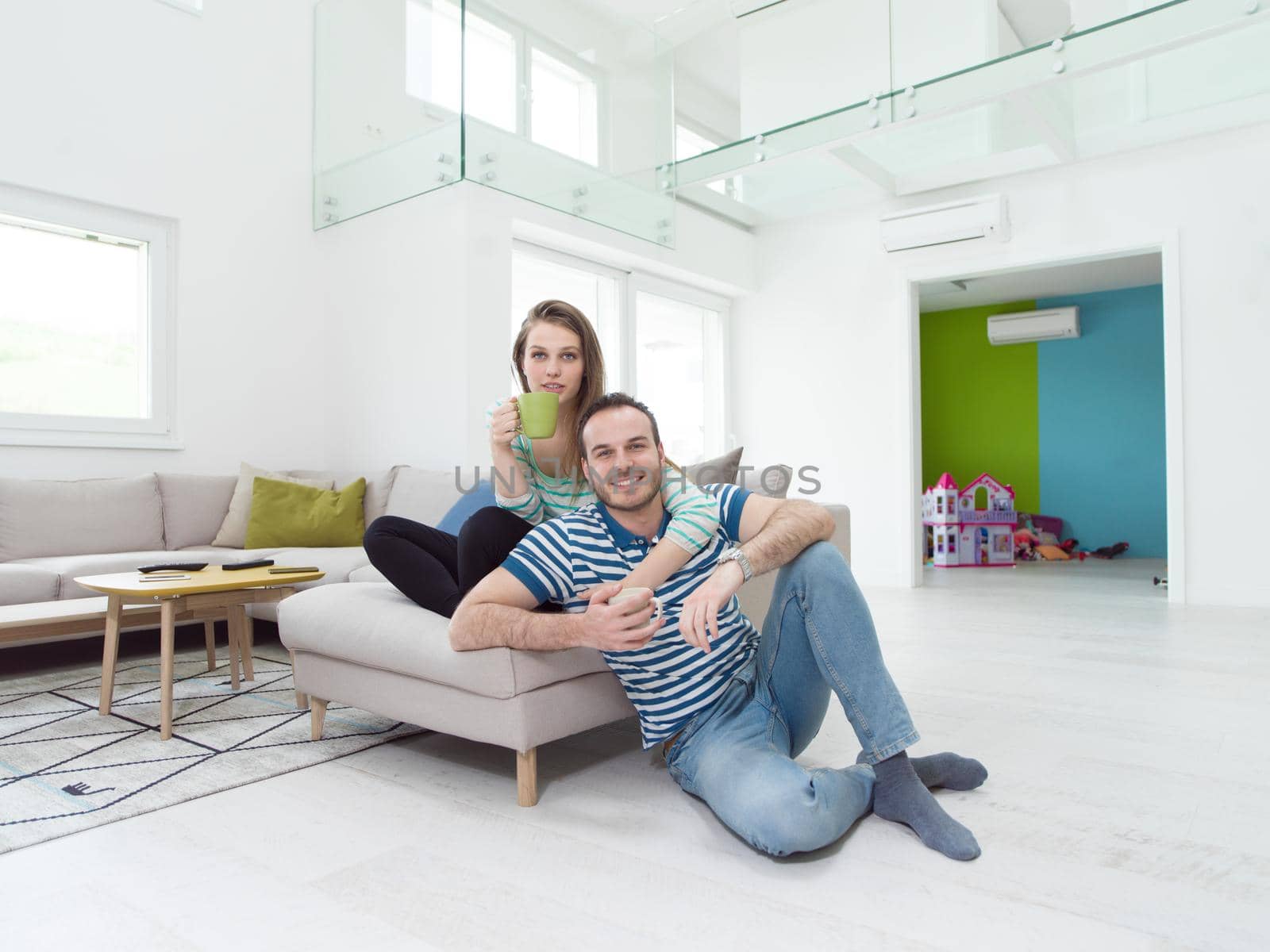 young beautiful handsome couple enjoying morning coffee at home