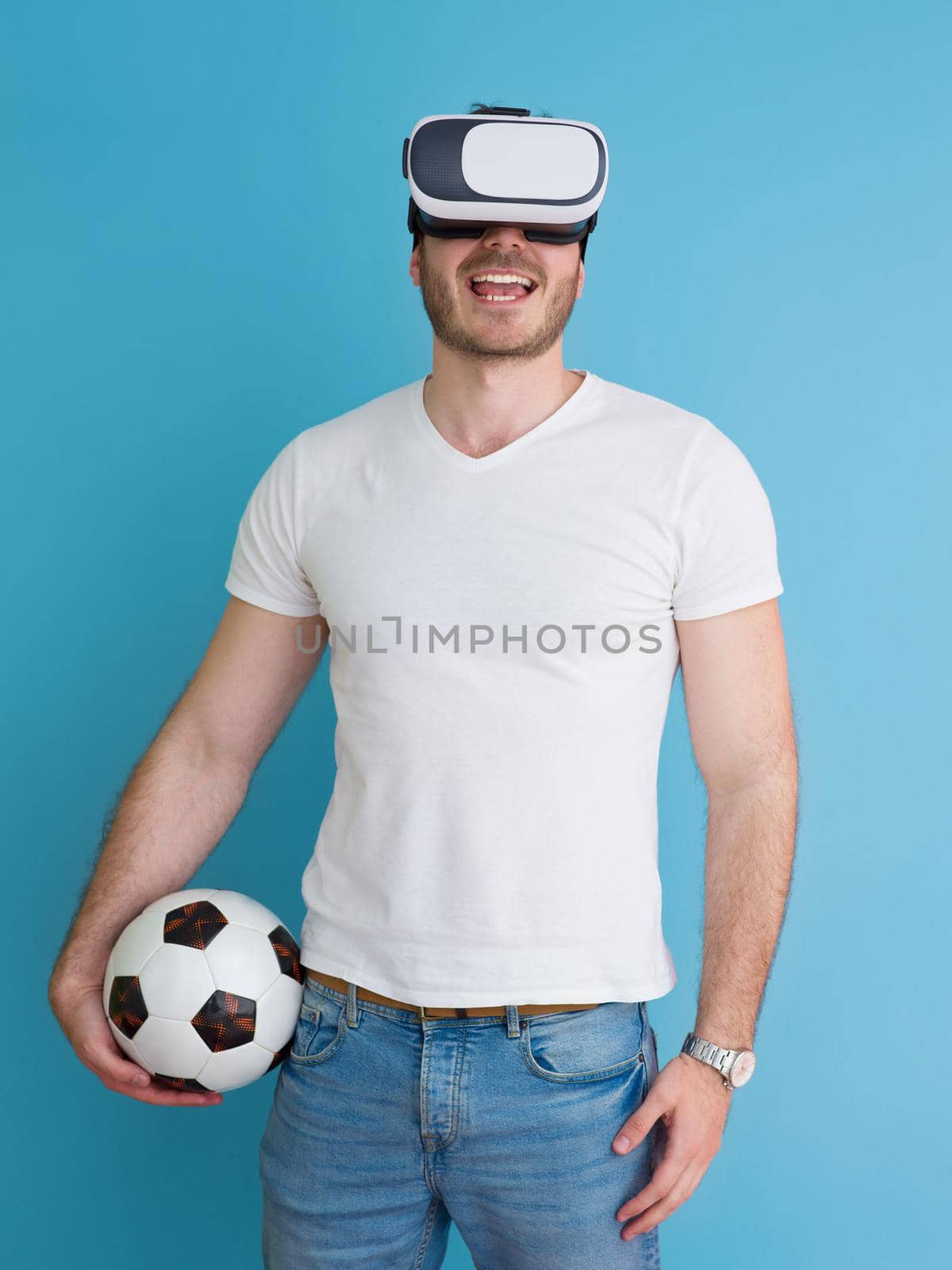 Happy man getting experience using VR headset glasses of virtual reality, isolated on blue background
