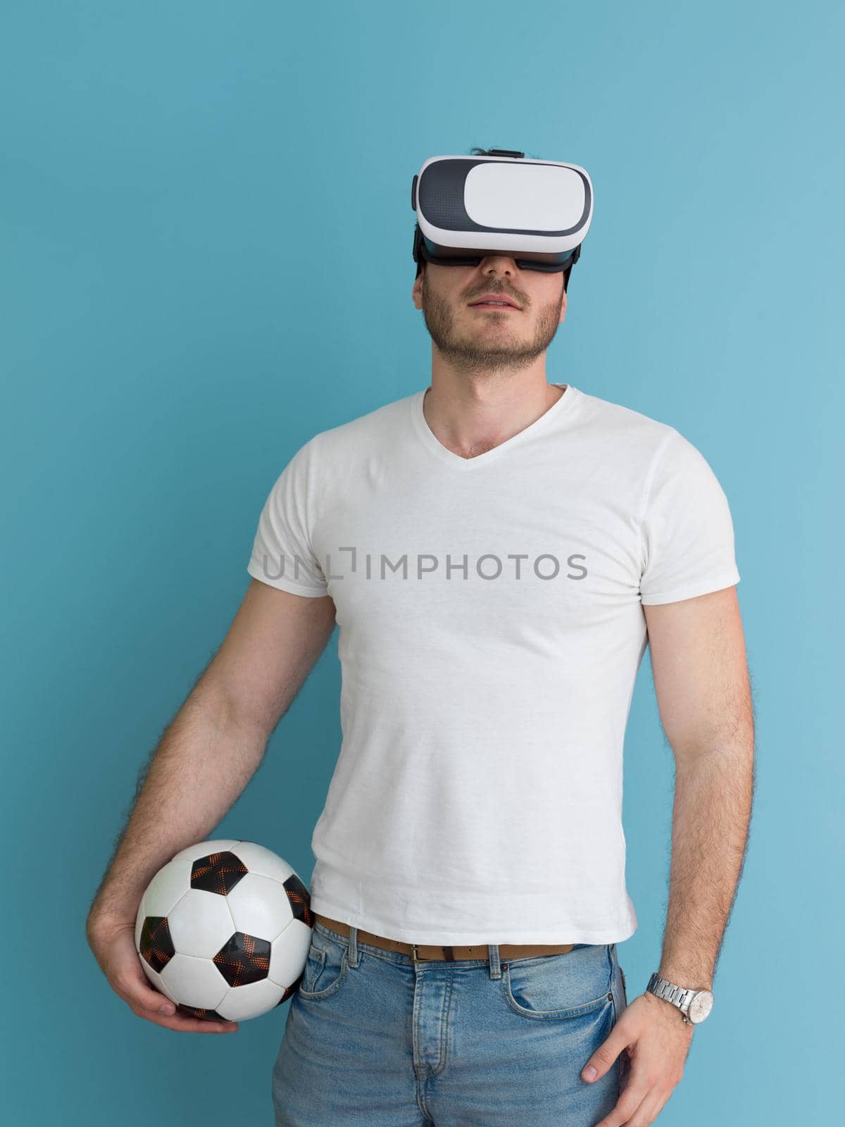 Happy man getting experience using VR headset glasses of virtual reality, isolated on blue background