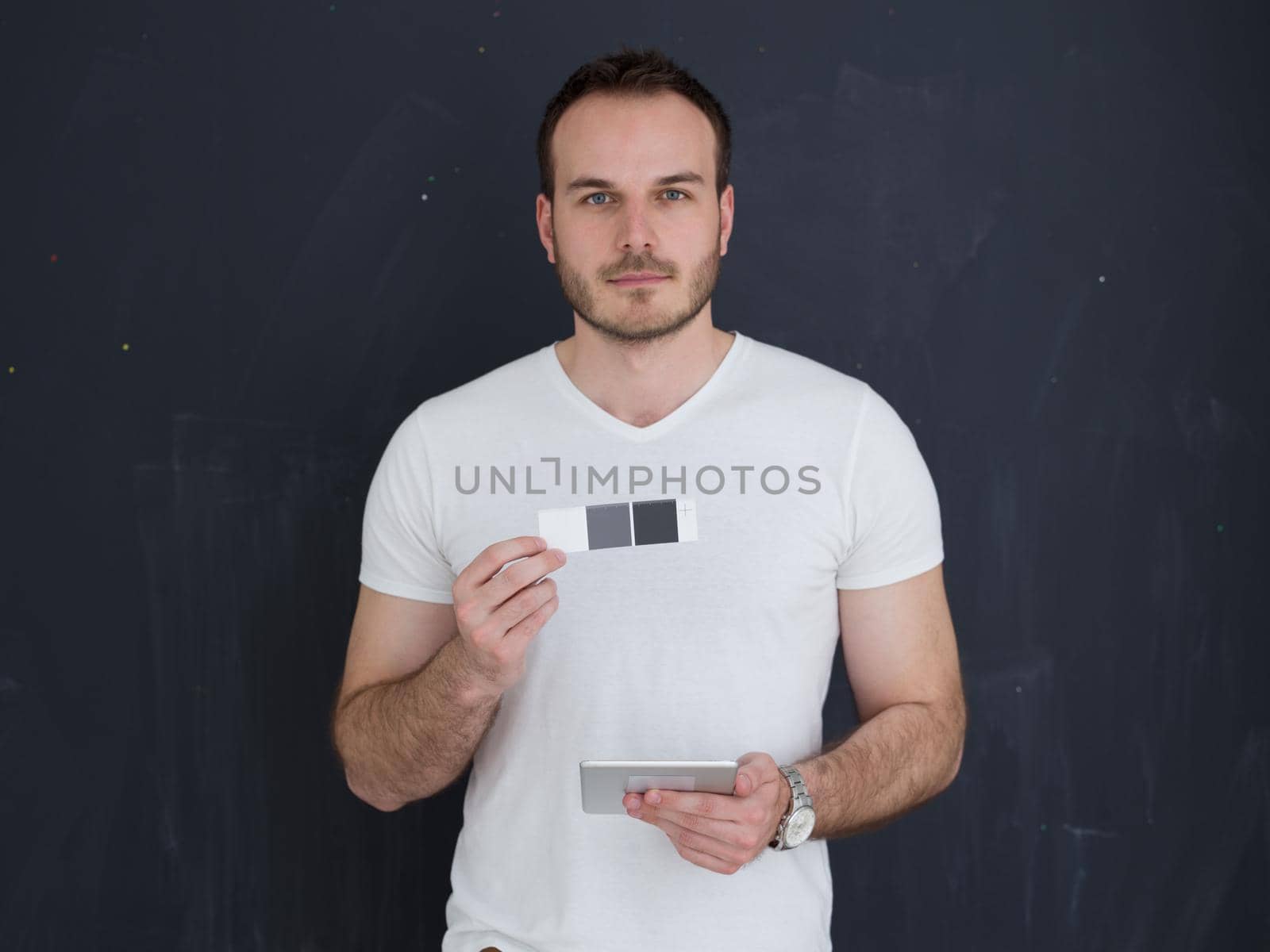 Happy young man using tablet computer isolated over gray background