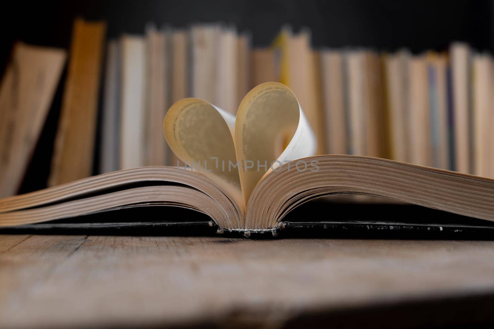 Open book. Heart-shaped pages. Booklover. Book background. Old books in the library. Bookshelf shop. Knowledge publications, literature. Bookish bookstore, bookshop. Flatlay top view.