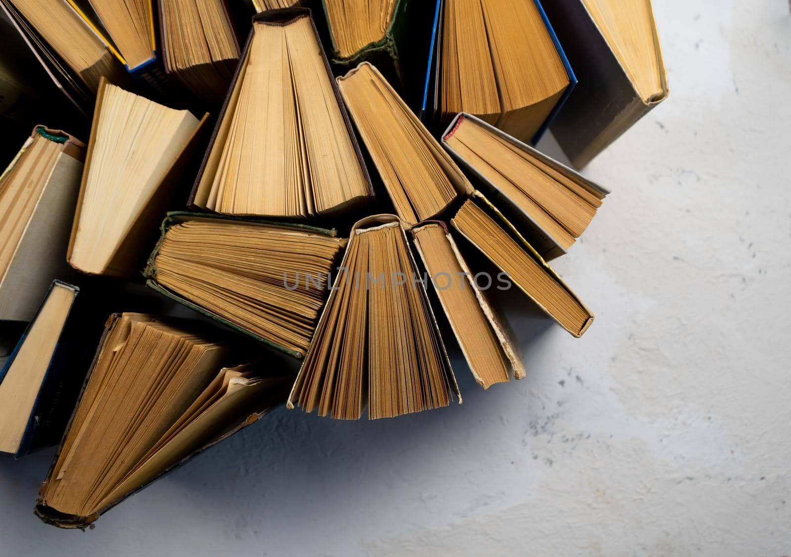 Book background. Old books in the library. Bookshelf shop. Knowledge publications, literature. Bookish bookstore, bookshop. Flatlay top view. Bookcrossing. Copy space.