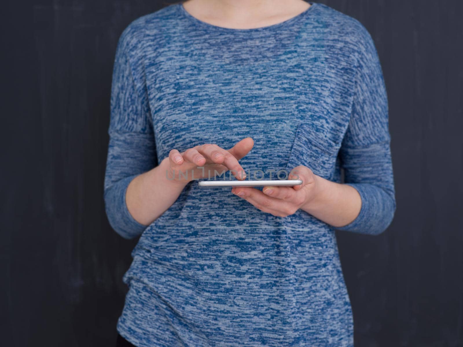 Happy young woman using tablet computer isolated over gray background