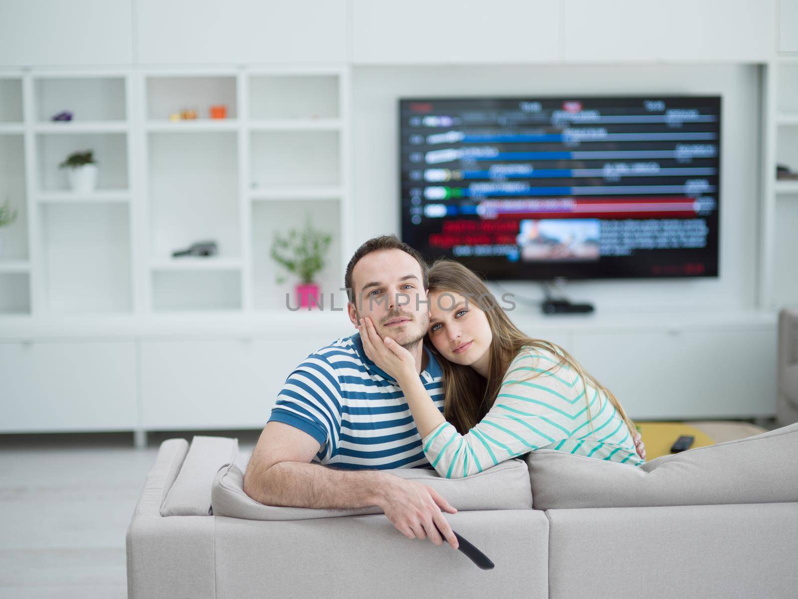 Young couple on the sofa watching television by dotshock