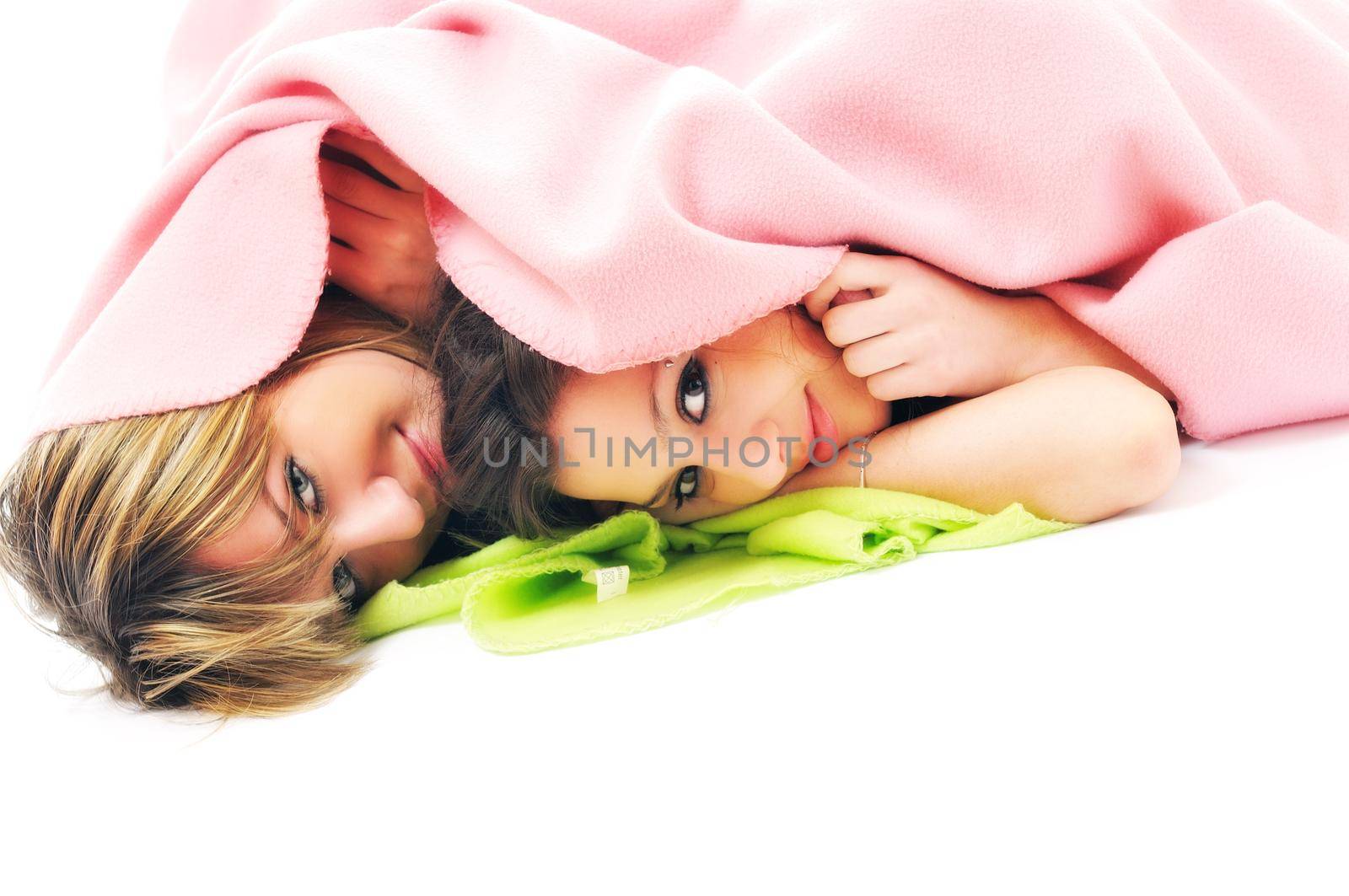 two youg happy giril woman smiling unger blanket isolated representing concept of lesbian love, happynes and softnes