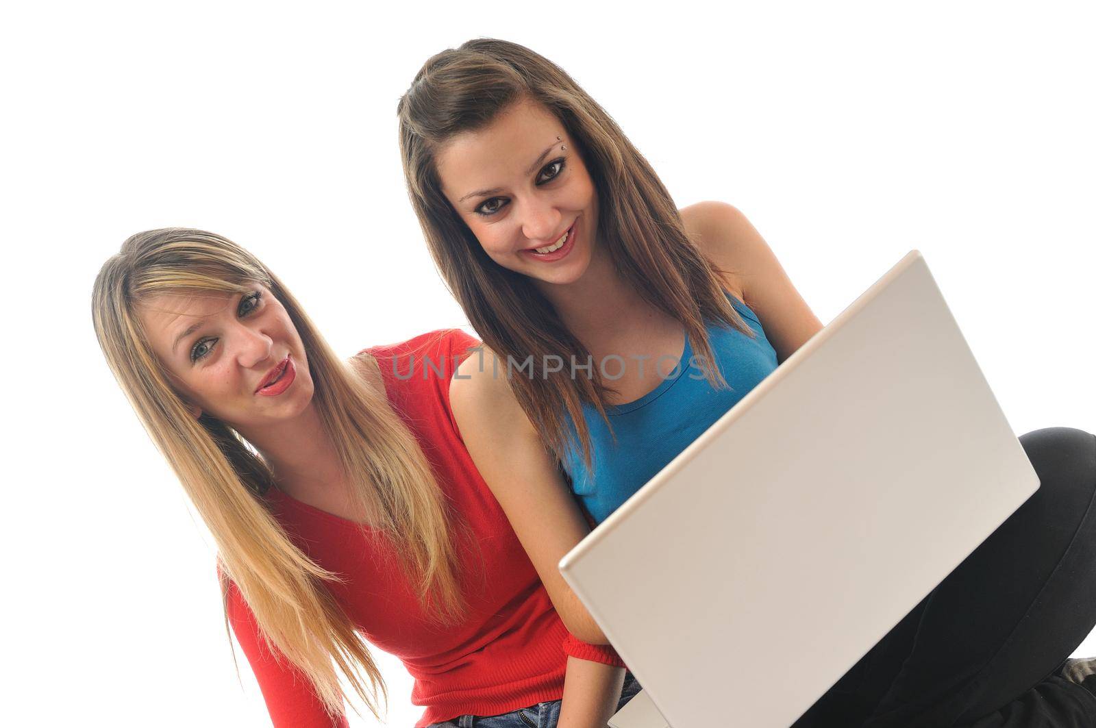 two young girls work on laptop isolated by dotshock