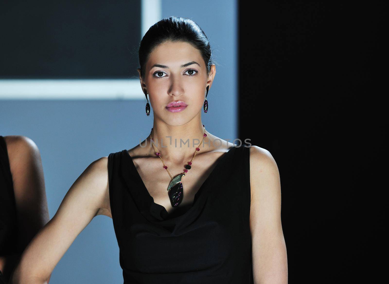 beautiful woman on fashion show piste with gold jawel