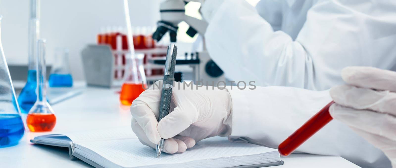 close up. a scientist making an entry in a laboratory journal. by SmartPhotoLab