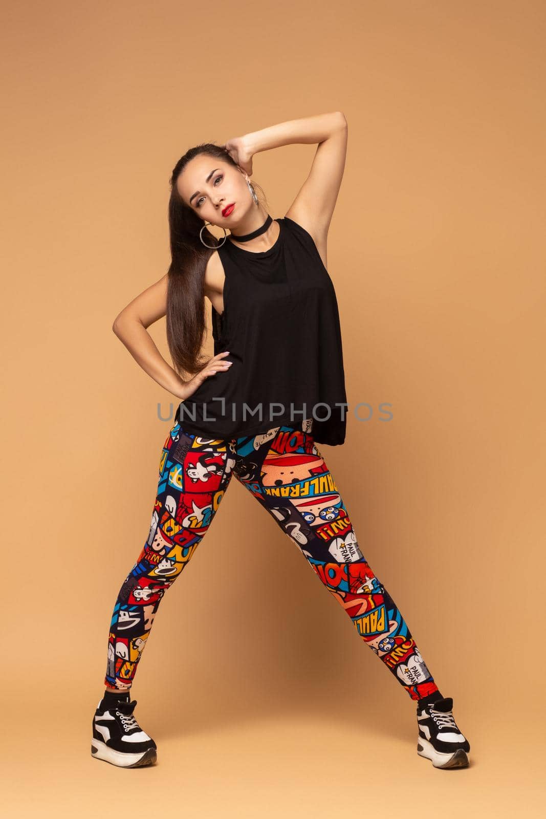 Modern style dancer posing on studio background. Dancer. Modern dance styles, dancehall, jazz funk, hip hop