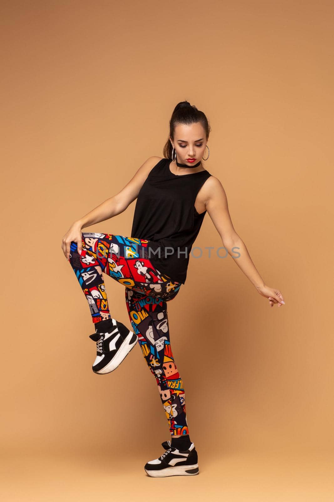 Modern style dancer posing on studio background. Dancer. Modern dance styles, dancehall, jazz funk, hip hop