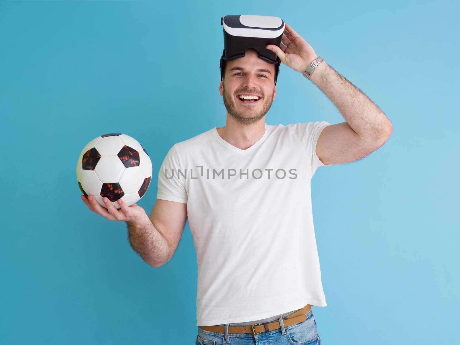 Happy man getting experience using VR headset glasses of virtual reality, isolated on blue background