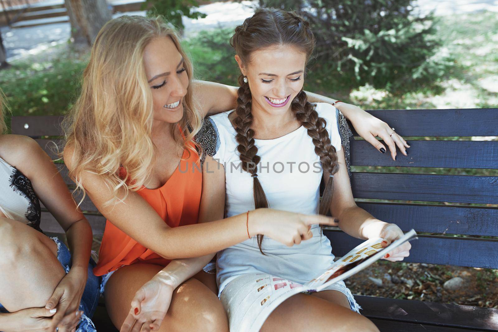 Girlfriends having fun and reading magazine