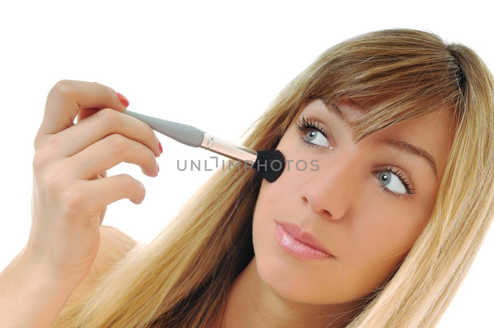 beautiful young woman apply powder makeup with brush isolated on white
