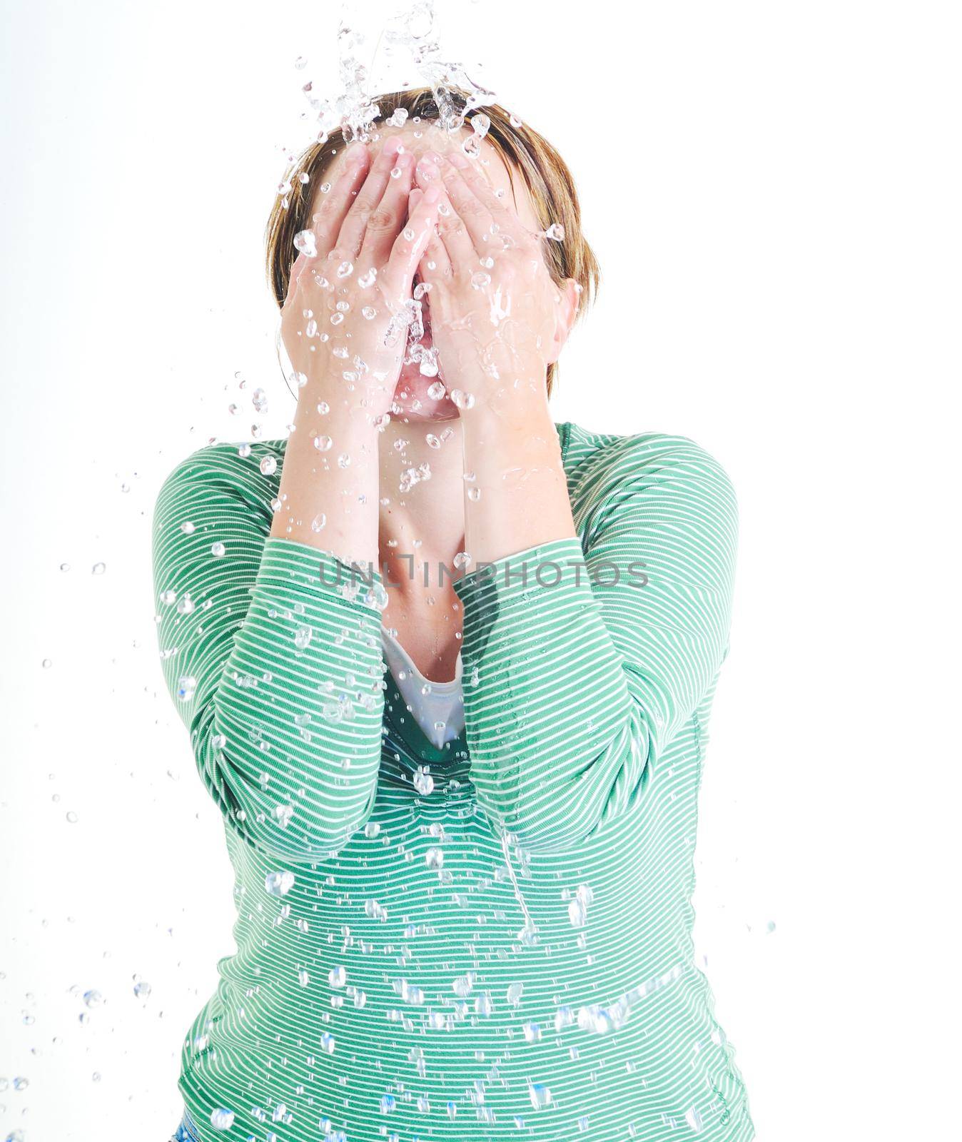bautiful young woman wash face with clean water isolated on white in studio
