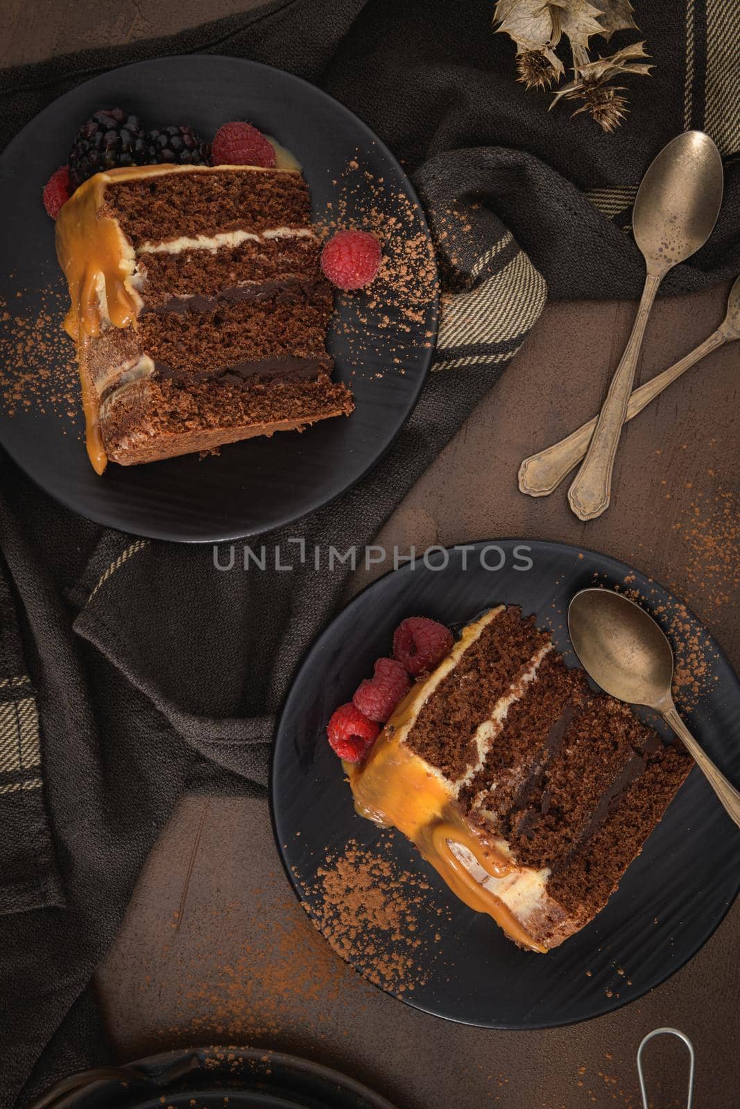 Delicious caramel cake slices with blackberries and raspberries.