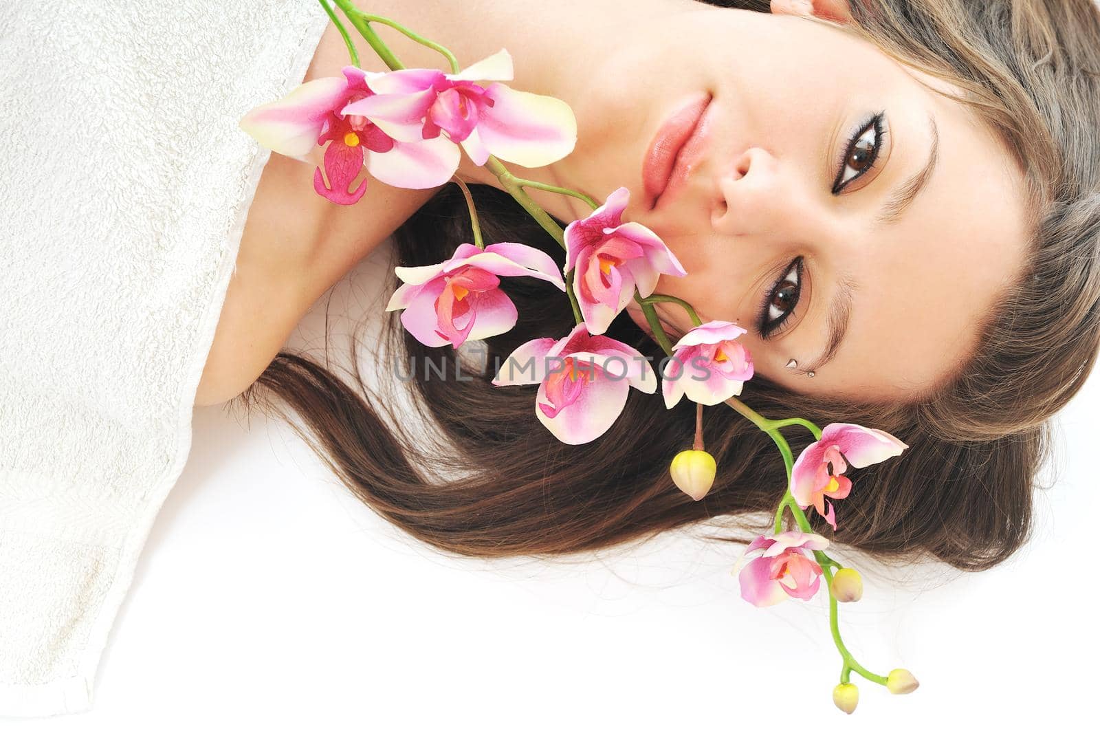 one  beautiful young  woman face with flower and towel