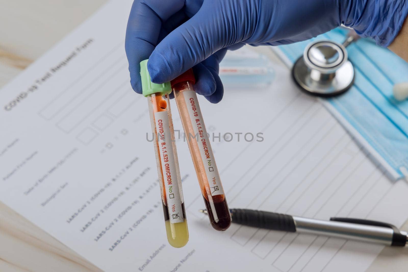 Coronavirus infected blood test sample in doctor hands. COVID-19 of new version Omicron B.1.1.529 epidemic virus outbreak by ungvar
