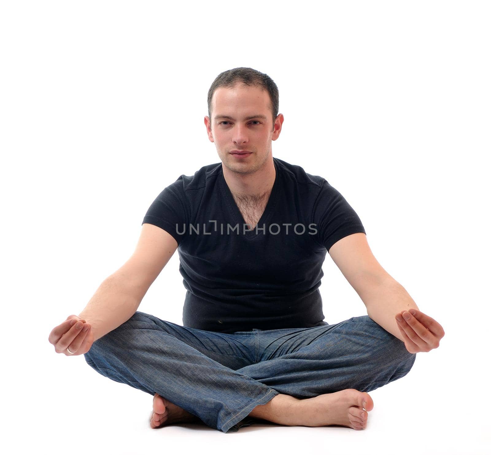 young man in lotus position exercising yoga by dotshock