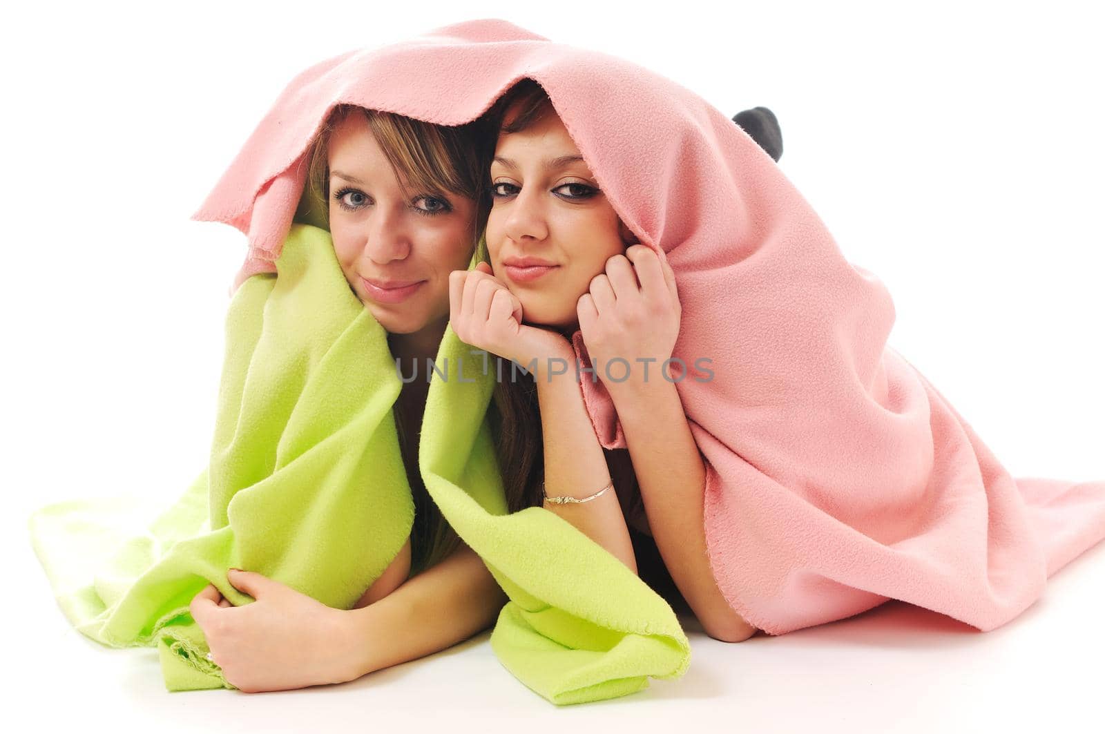 two youg happy giril woman smiling unger blanket isolated representing concept of lesbian love, happynes and softnes