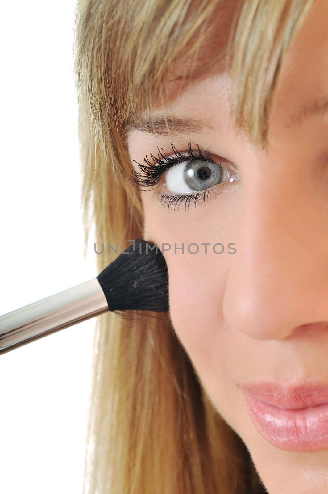 beautiful young woman apply powder makeup with brush isolated on white