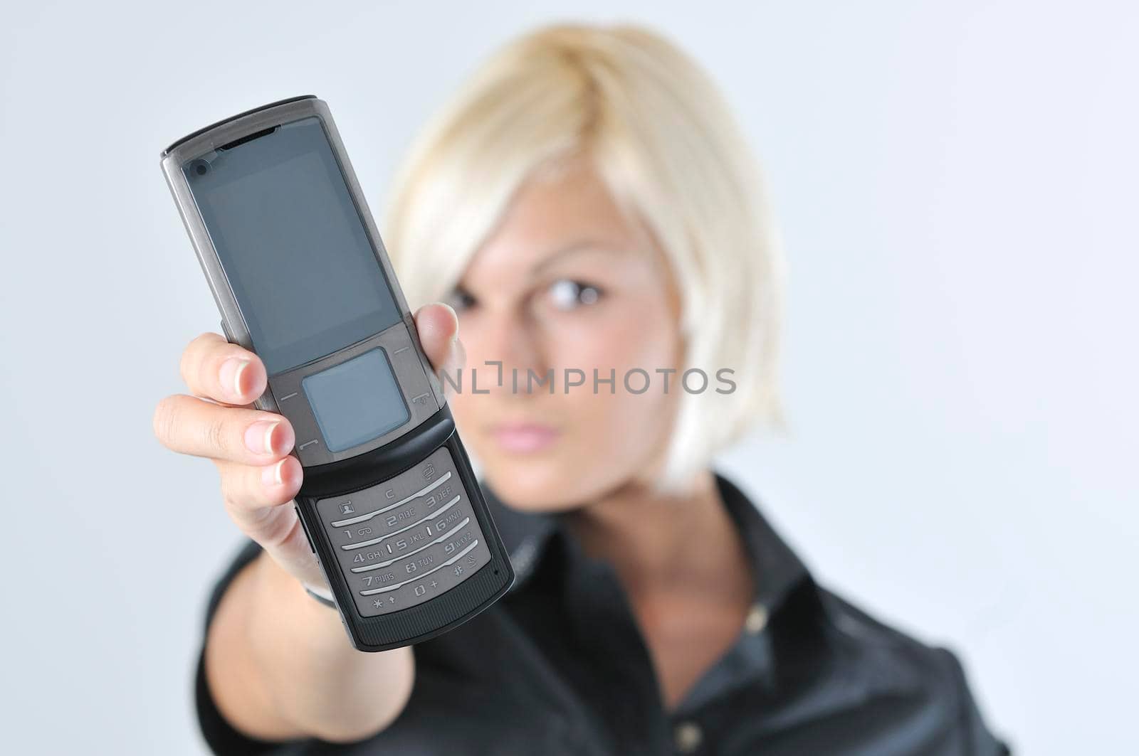 portrait of young blonde business woman holding new modern cellphone