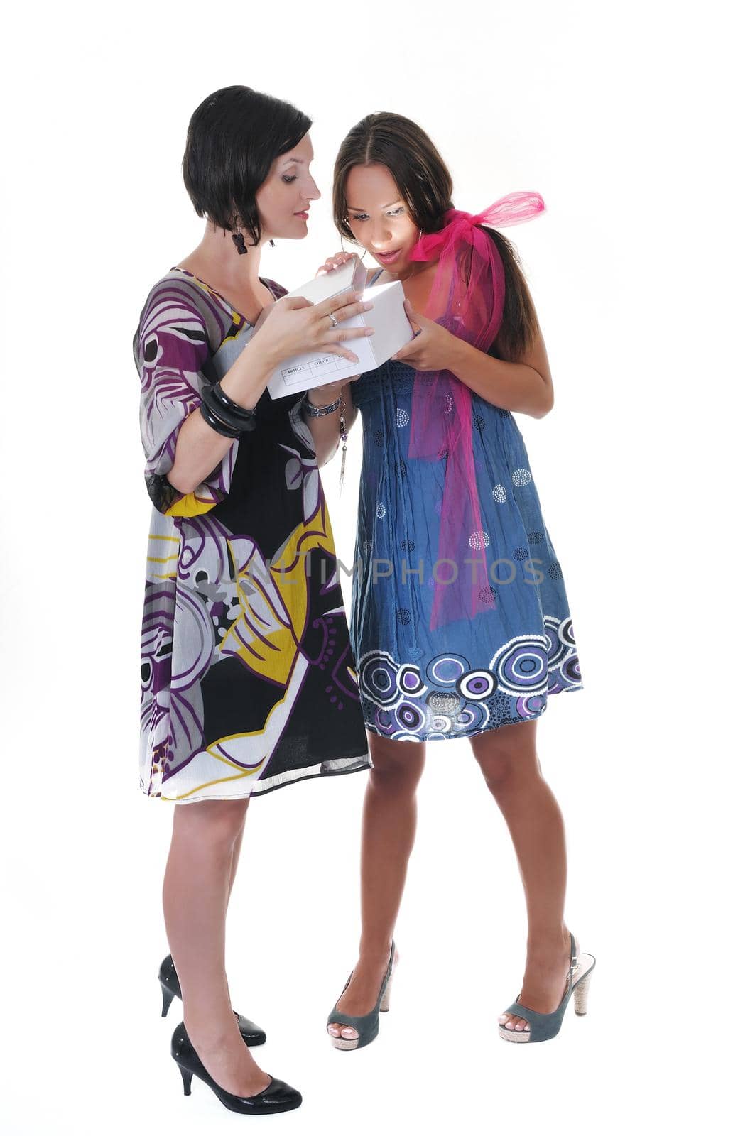 two young happy woman giving gift and looking in box at holiday season