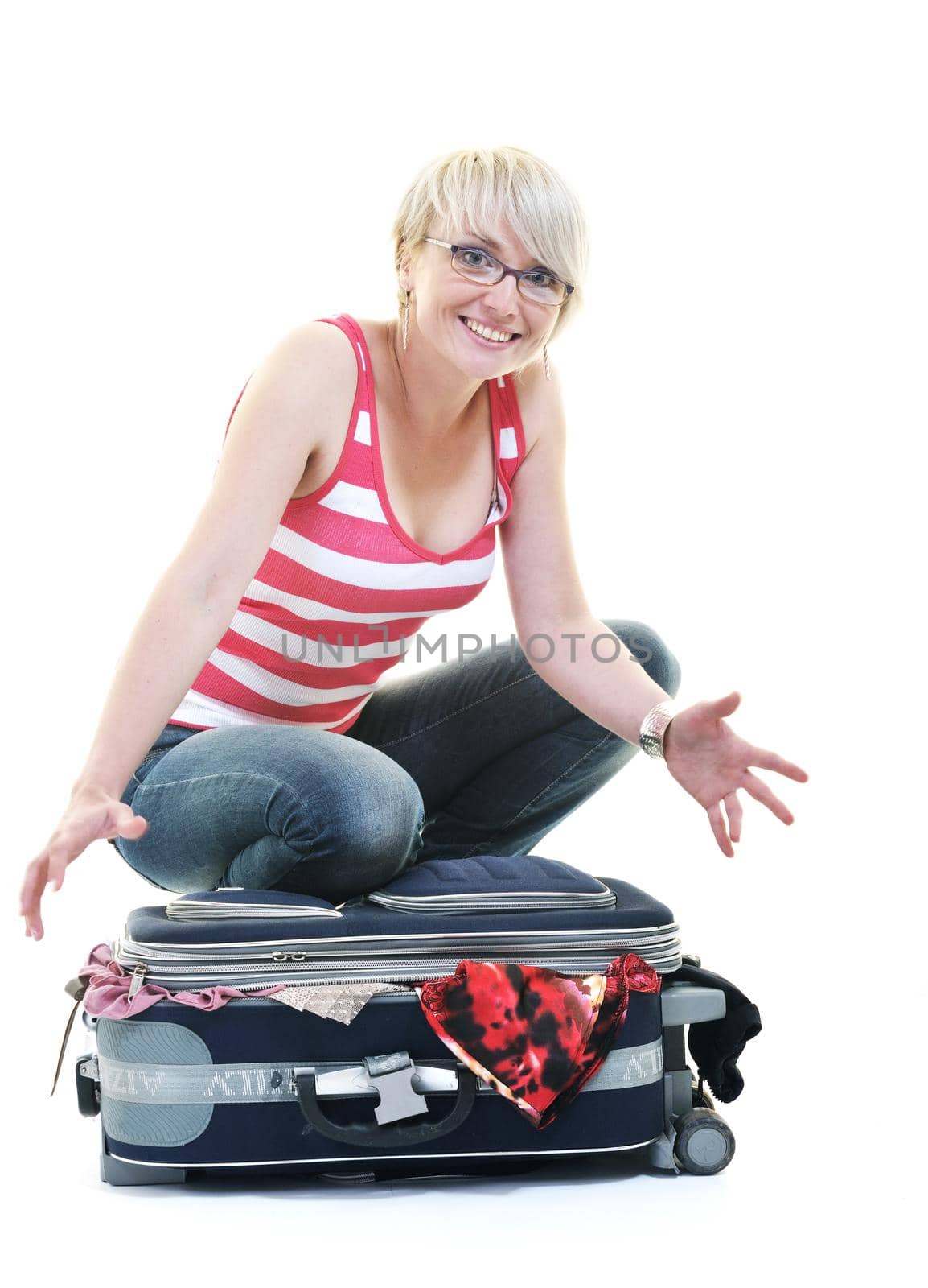 woman tourist packing travel bag isolated on white backgound in studio