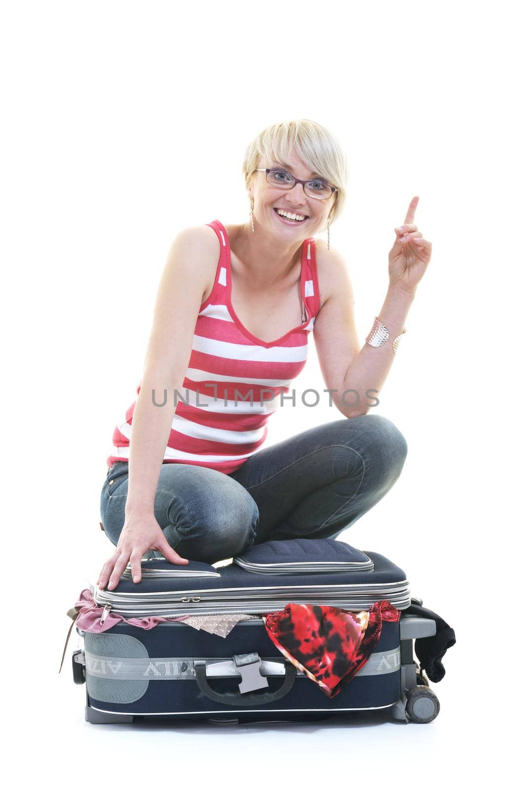 woman tourist packing travel bag isolated on white backgound in studio