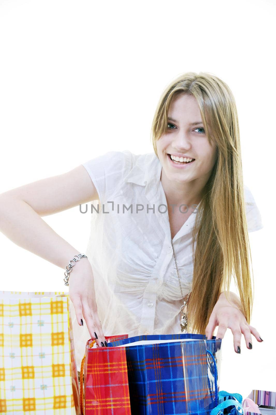 women shopping concept with young lady and colored bags  isolated over white background in studio