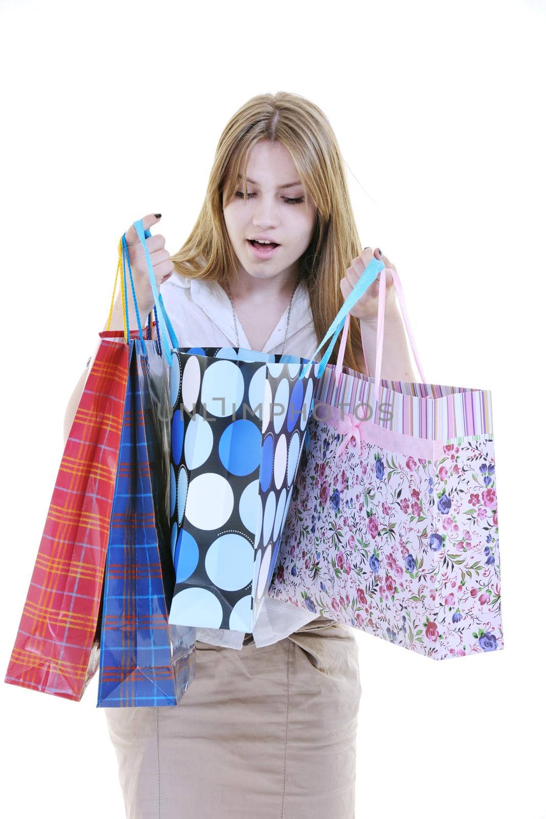 women shopping concept with young lady and colored bags  isolated over white background in studio