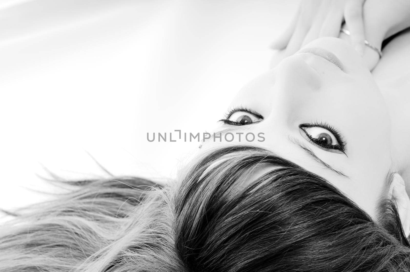 young woman with beautiful face lie on floor isolated closeup