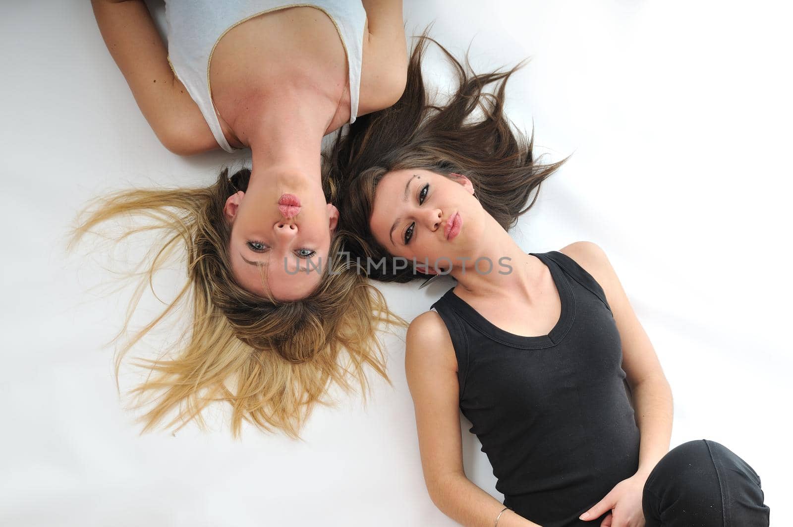 young woman with beautiful face lie on floor isolated closeup