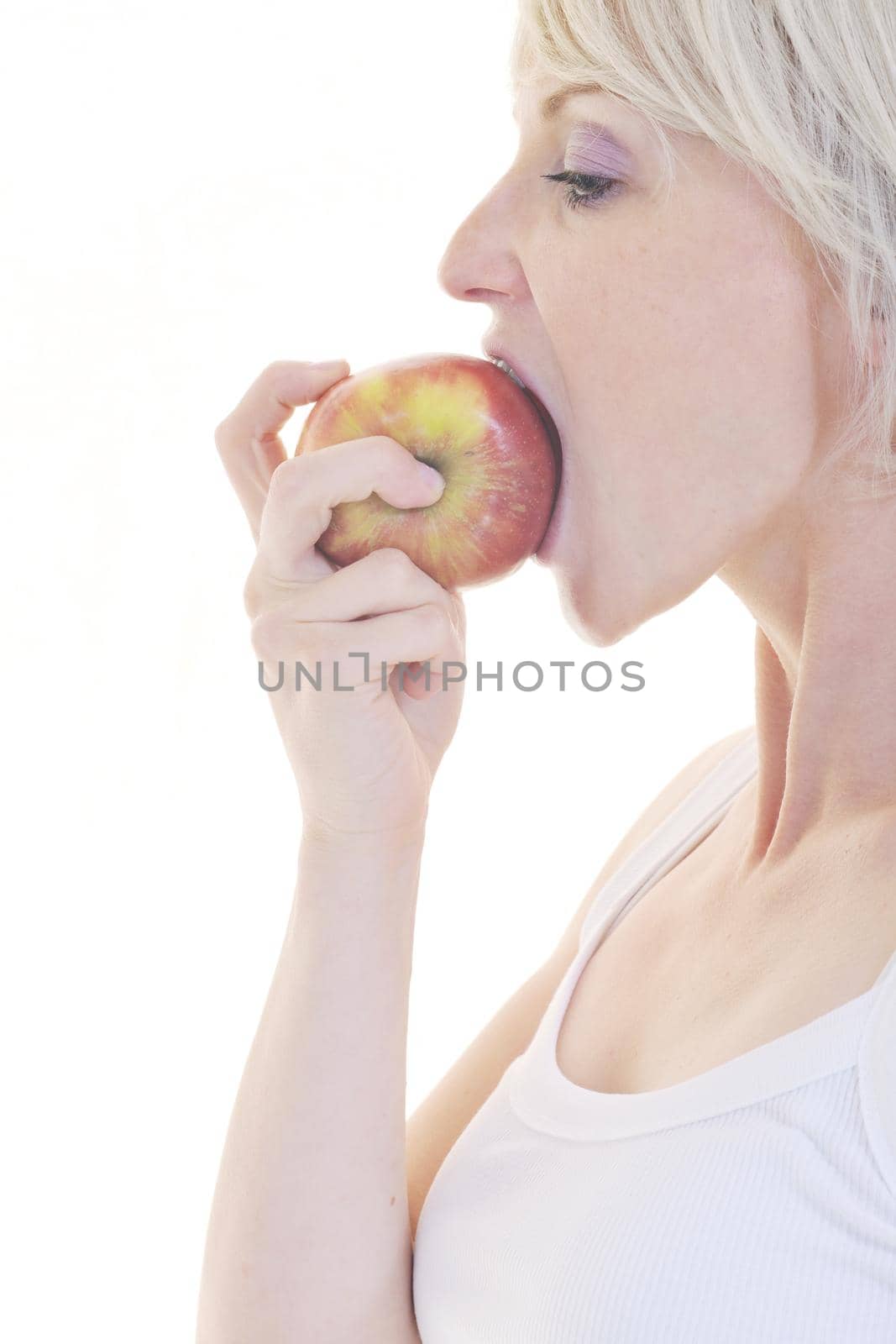 woman eat green apple isolated  on white backround in studio representing healthy lifestile and eco food concept