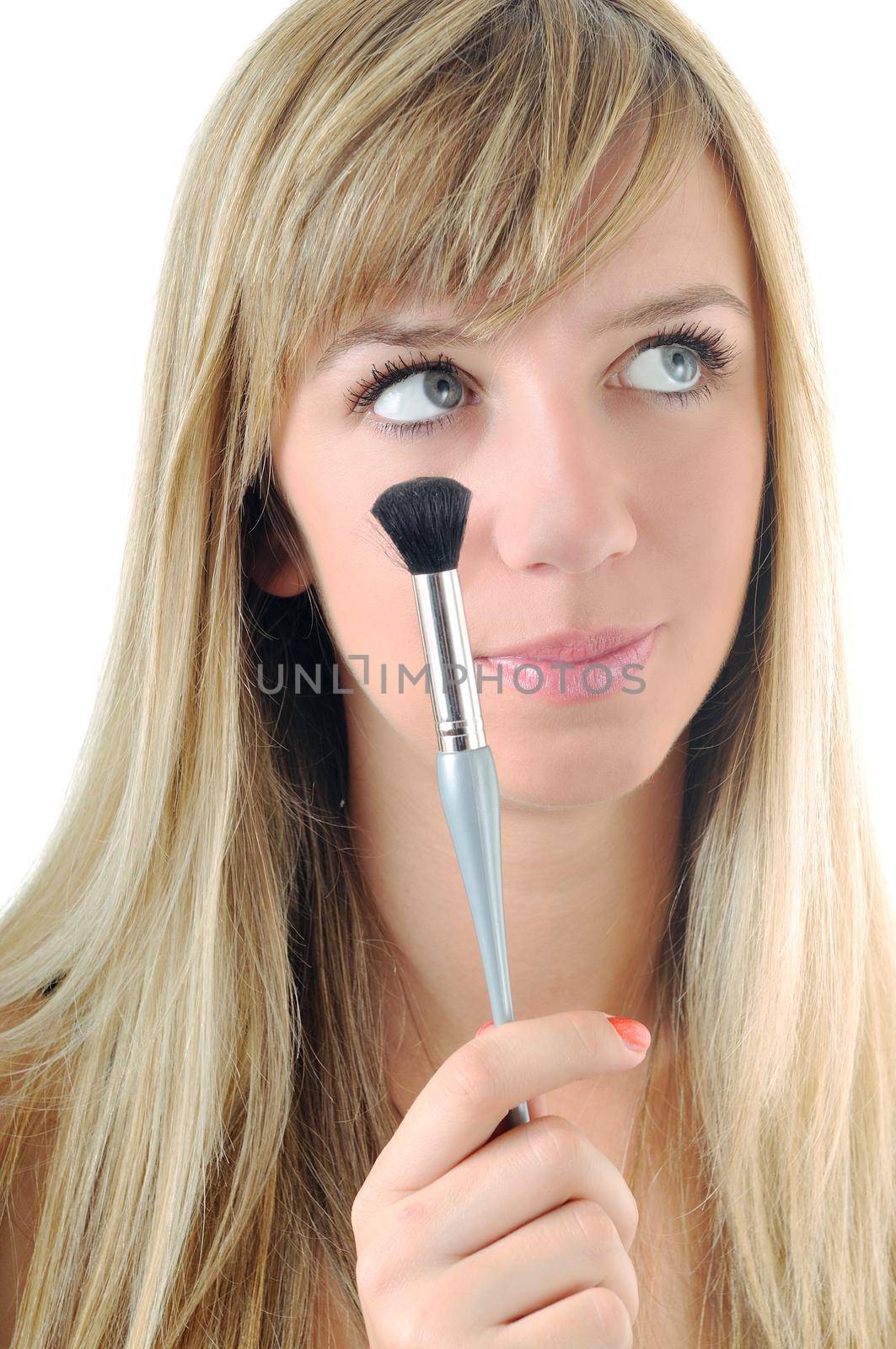 beautiful young woman apply powder makeup with brush isolated on white