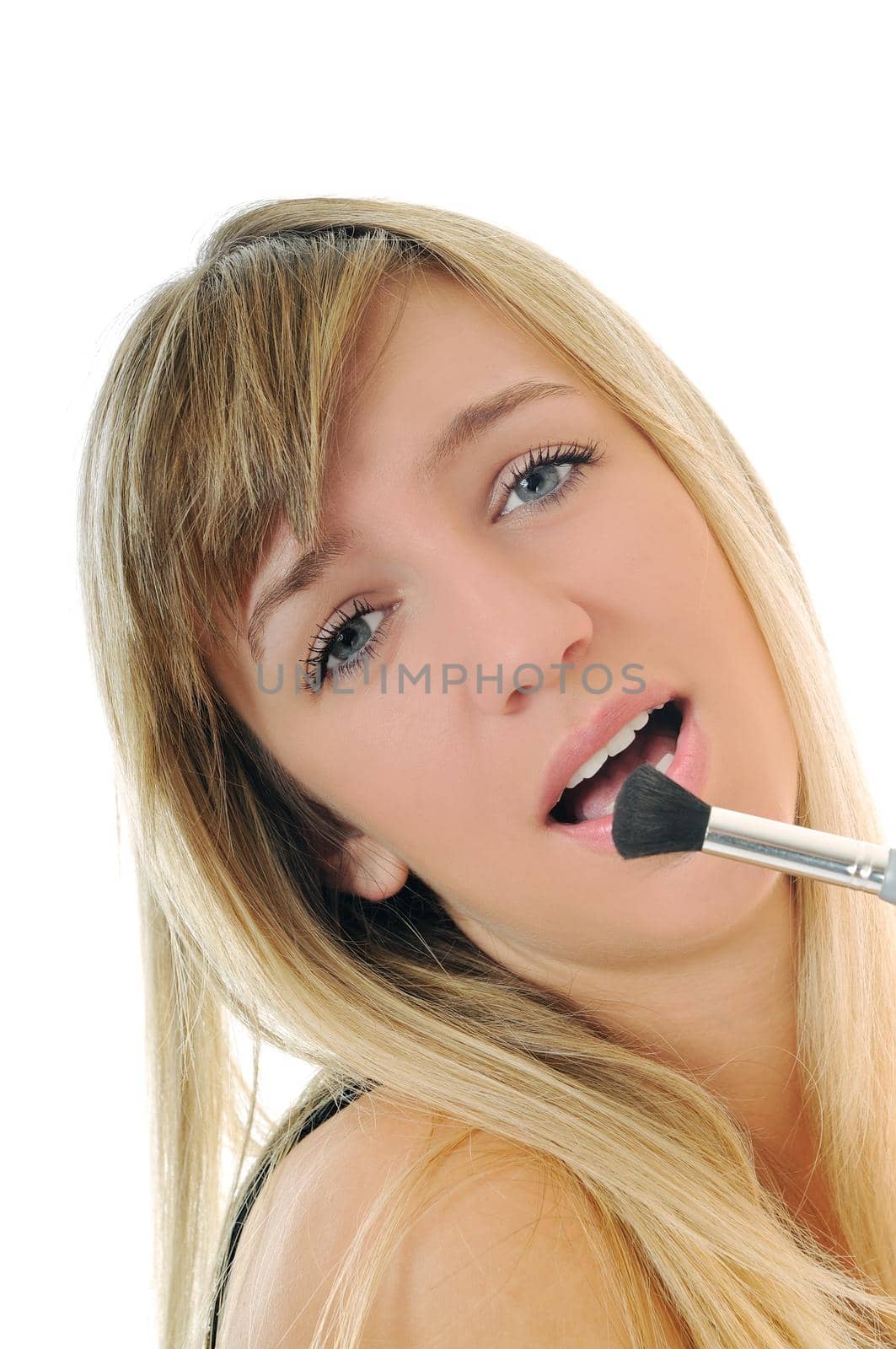 beautiful young woman apply powder makeup with brush isolated on white