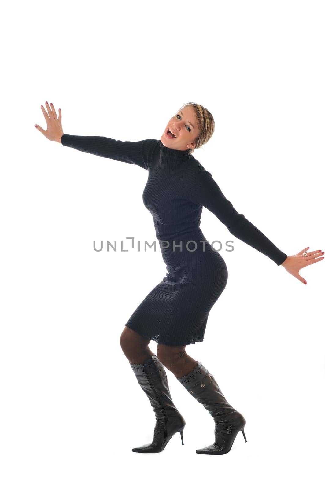 isolated happy woman in black dress and boots posing 