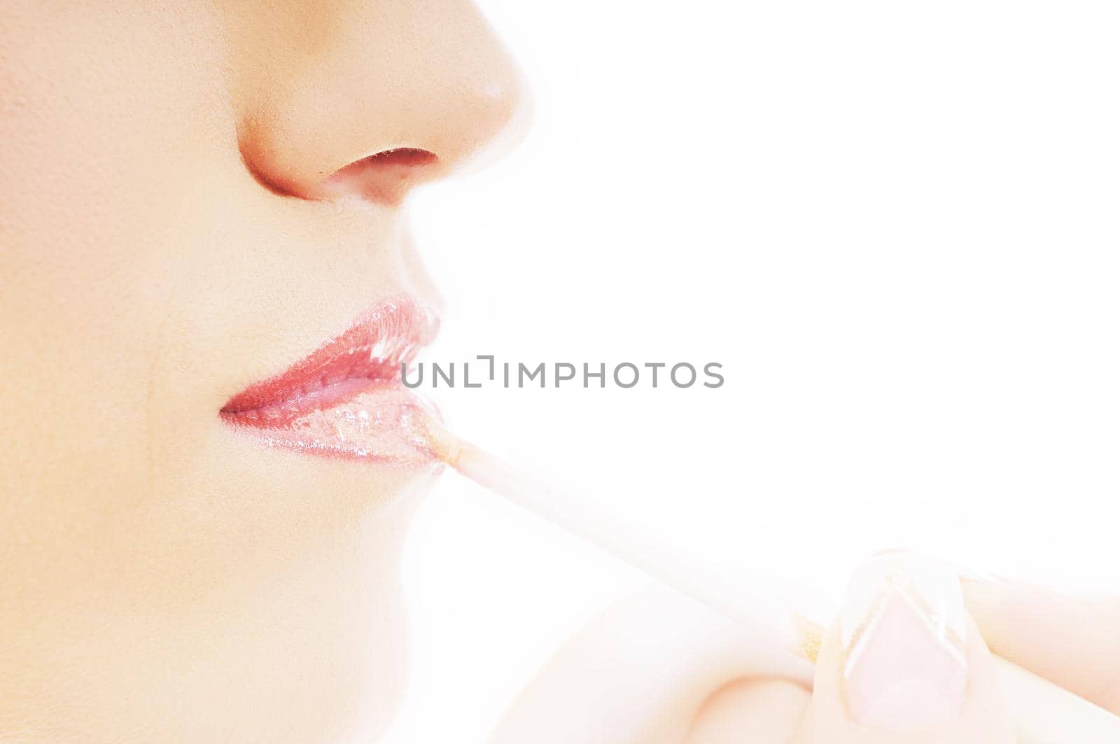 makeup treatment with professional makeup artist and beautiful brunette woman  isolated on white in studio