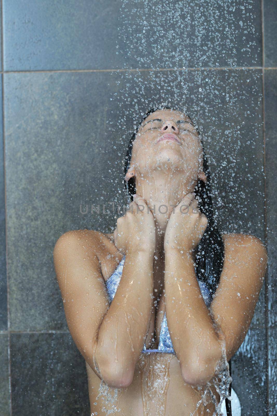 Portrait of a sexy young woman enjoing bath under water shower