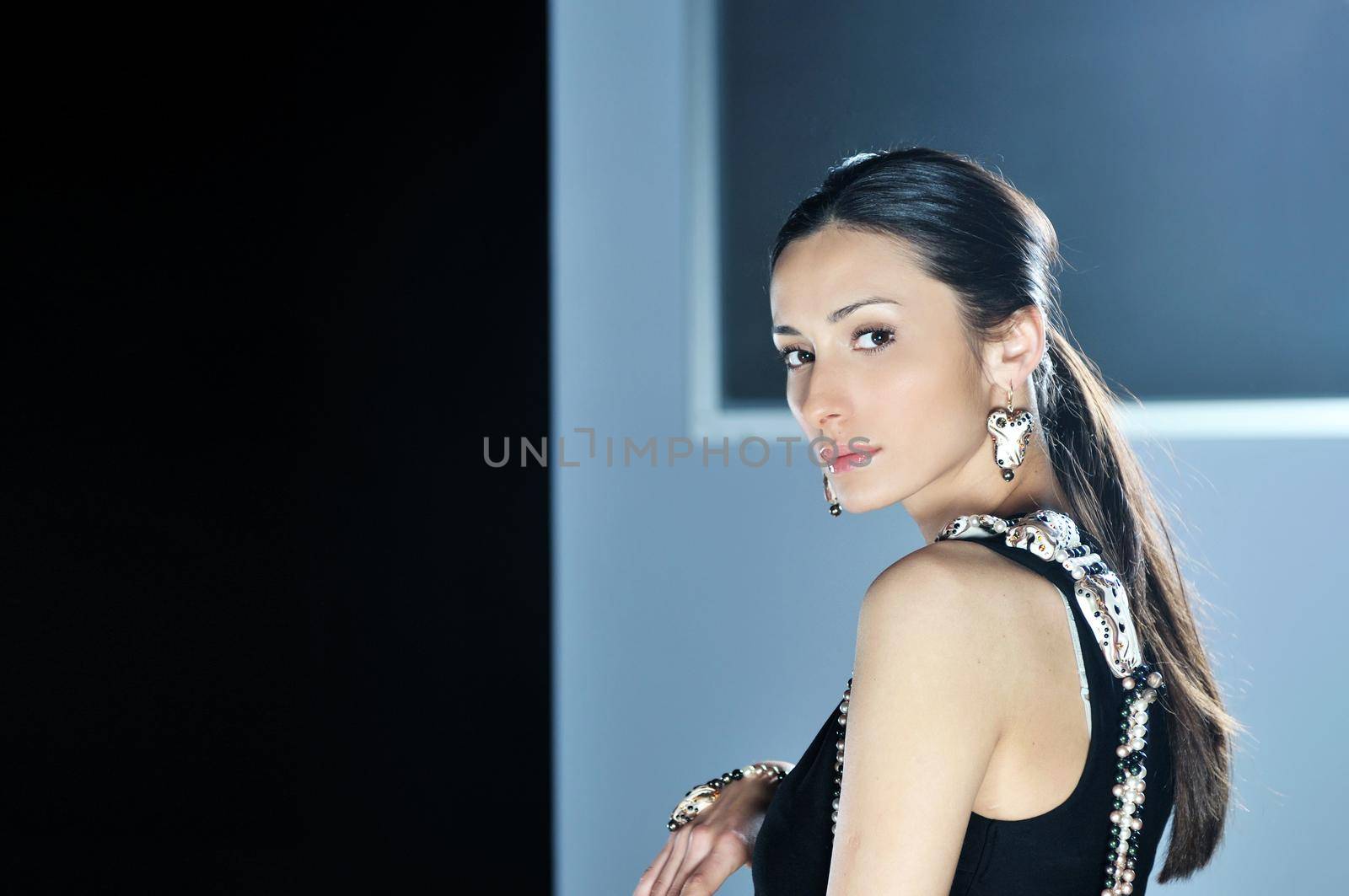 beautiful woman on fashion show piste with gold jawel